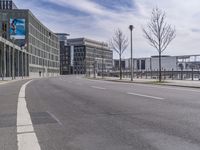 the road is empty and no traffic on it, in front of an industrial building