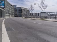 the road is empty and no traffic on it, in front of an industrial building