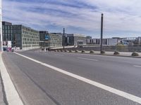 the road is empty and no traffic on it, in front of an industrial building