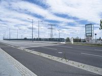 an empty road and two lanes with blue sky background, on a cloudy day in the city