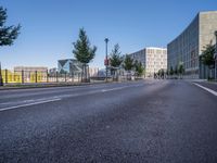 the empty road near some tall buildings in a city neighborhood near the water with an arrow pointing to the building