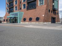 an empty road near two apartment buildings in a big city area with red brick walls