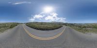 an empty empty road with sun shining on the horizon and mountains behind it in this 360 view