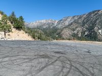 a empty road near some mountains and trees on a mountain slope in california state, usa