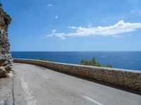 an empty road that has no traffic at all on it with a view over the ocean