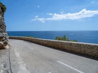 an empty road that has no traffic at all on it with a view over the ocean