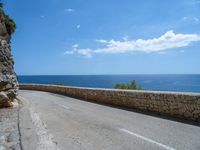 an empty road that has no traffic at all on it with a view over the ocean