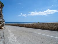 an empty road that has no traffic at all on it with a view over the ocean