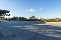 the empty road and curb outside the city building area has a large tire marks in it