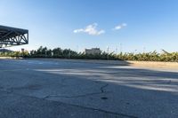 the empty road and curb outside the city building area has a large tire marks in it