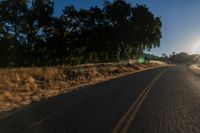 an empty road is seen through the lens of a car in motion down the side of the road