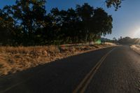 an empty road is seen through the lens of a car in motion down the side of the road