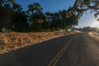 an empty road is seen through the lens of a car in motion down the side of the road