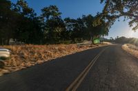 an empty road is seen through the lens of a car in motion down the side of the road