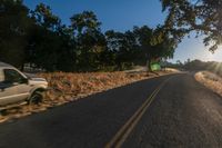 an empty road is seen through the lens of a car in motion down the side of the road