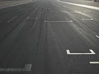 a street view in the sunlight and sun setting on it with an empty road in the foreground