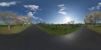 a 360 - lens image of an empty road at night with sun and clouds in the sky