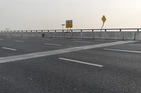 there is an empty road next to some lights and a billboard that looks like it has been taken over