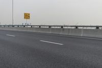 there is an empty road next to some lights and a billboard that looks like it has been taken over