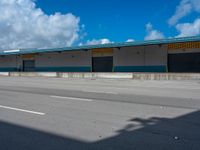 an empty lot with an empty parking lot in the background and clouds in the distance