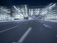 an empty road in a modern city at night with buildings and lamps on both sides