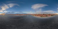 the road is empty and the sky is very blue and white with no clouds on it