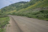 an empty road with a mountain in the backrouch, which is not quite visible