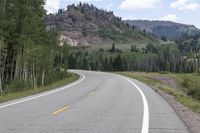 the road is empty during the day in the mountains along a highway with no cars