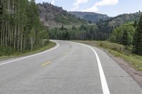 the road is empty during the day in the mountains along a highway with no cars