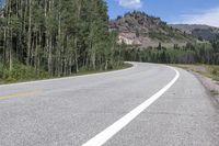 the road is empty during the day in the mountains along a highway with no cars