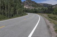 the road is empty during the day in the mountains along a highway with no cars