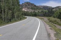 the road is empty during the day in the mountains along a highway with no cars