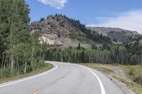 the road is empty during the day in the mountains along a highway with no cars