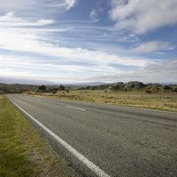 Empty Road: Embracing Nature on a Sunny Day with Clouds