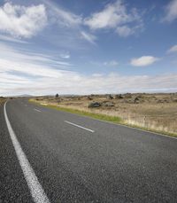 Empty Road: Embracing Nature on a Sunny Day with Clouds