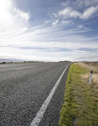 Empty Road: Embracing Nature on a Sunny Day with Clouds