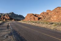 the road in the middle of the desert is empty and looks like it can be taken off the car