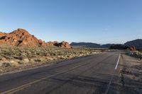 the road in the middle of the desert is empty and looks like it can be taken off the car