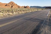 the road in the middle of the desert is empty and looks like it can be taken off the car