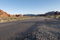 the road in the middle of the desert is empty and looks like it can be taken off the car