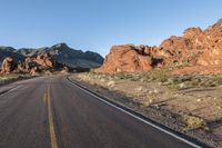 the road in the middle of the desert is empty and looks like it can be taken off the car