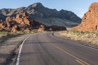 the road in the middle of the desert is empty and looks like it can be taken off the car