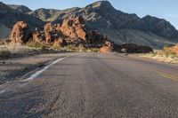 the road in the middle of the desert is empty and looks like it can be taken off the car