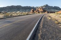 the road in the middle of the desert is empty and looks like it can be taken off the car