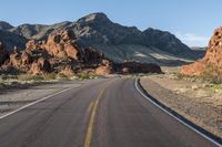 the road in the middle of the desert is empty and looks like it can be taken off the car