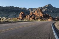 the road in the middle of the desert is empty and looks like it can be taken off the car