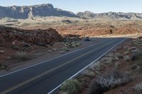 the road in the middle of the desert is empty and looks like it can be taken off the car