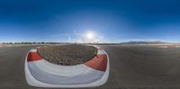 a small guy is racing down an empty road on skis and ski poles near a mountain