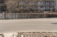 the road is empty and has rocks on it by a large rock next to a street