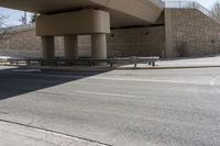 the shadow on the side of an empty road on a sunny day with no clouds